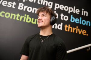 Young man wearing headphones at YMCA supported housing